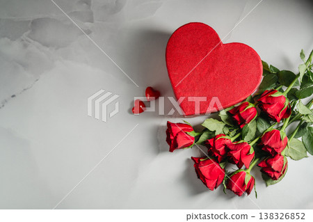 Valentine's Day background. Red roses flowers and heart gift box on bright background. Festive greeting card, flat lay Valentine's Day background. Red roses flowers and heart gift box on bright background. Festive greeting card, flat lay 138326852