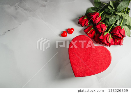 Valentine's Day background. Red roses flowers and heart gift box on bright background. Festive greeting card, flat lay 138326869
