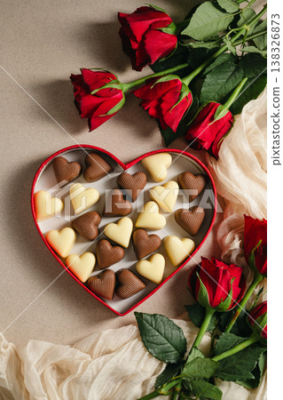 Valentine's Day background, heart gif box with heart chocolates and bouquet of red roses flowers. Mother's day concept Valentine's Day background, heart gif box with heart chocolates and bouquet of red roses flowers. Mother's day concept 138326873