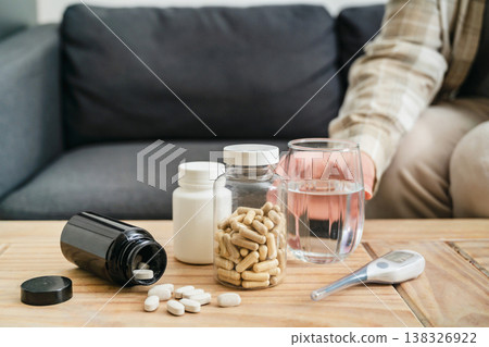 Sickness and health issues. Bottles with pills and capsules on the table, seasonal cold and flu concept. Medical treatment 138326922