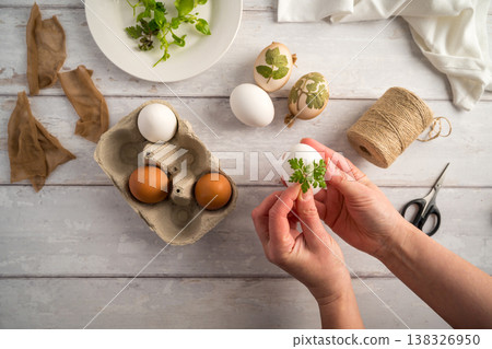 DIY Easter eggs with natural leaves, creating patterns on eggs using plants. Eco friendly colouring easter eggs DIY Easter eggs with natural leaves, creating patterns on eggs using plants. Eco friendly colouring easter eggs 138326950