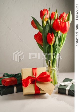 Mothers' day. Red tulips with gift boxes. Easter holiday. Bright background Mothers' day. Red tulips with gift boxes. Easter holiday. Bright background 138327035