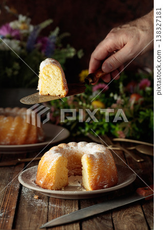 Easter cakes and spring flowers on an old wooden table. Easter cakes and spring flowers on an old wooden table. 138327181