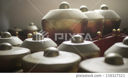 Magelang, Indonesia - December 8, 2025, Close-up of traditional Indonesian gamelan percussion instruments made of bronze Magelang, Indonesia - December 8, 2025, Close-up of traditional Indonesian gamelan percussion instruments made of bronze 138327321