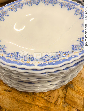 Beautifully stacked porcelain plates with floral design standing tall Beautifully stacked porcelain plates with floral design standing tall 138327653