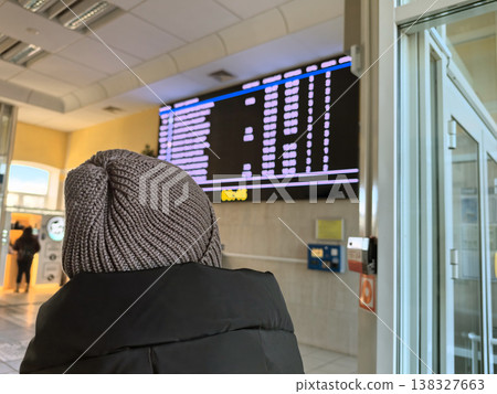Waiting for the next train at a busy train station in winter Waiting for the next train at a busy train station in winter 138327663