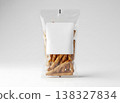 Transparent standup bag with blank square label holding salted pretzel snacks 138327834