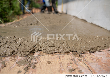 Concrete pouring process at construction site industrial action detailed view urban environment Concrete pouring process at construction site industrial action detailed view urban environment 138327874