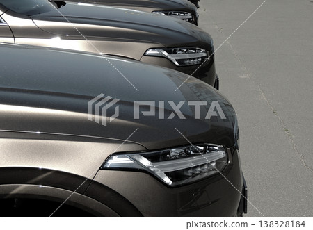 Front part of the same cars stay in line on the asphalt  138328184