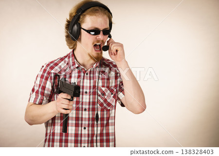 Gamer man shooting from gun Gamer man shooting from gun 138328403