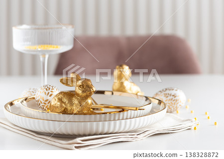 Easter Table Setting with Plates and Golden Decor on White Table Easter Table Setting with Plates and Golden Decor on White Table 138328872