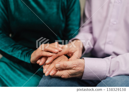 Old couple hands. Senior couple in love holding hands. Mid age old husband wife touching hands with tenderness love enjoying wellbeing. Grandmother grandfather together. Family moment love and care Old couple hands. Senior couple in love holding hands. Mid age old husband wife touching hands with tenderness love enjoying wellbeing. Grandmother grandfather together. Family moment love and care 138329138