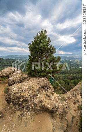 Majestic rocky cliffs and towering pine trees against blue sky. Majestic rocky cliffs and towering pine trees against blue sky. 138329527