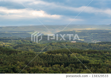 Layers of green mountains and hills in the haze during sunset. Panoramic View of Green hills and Meadow. 138329533