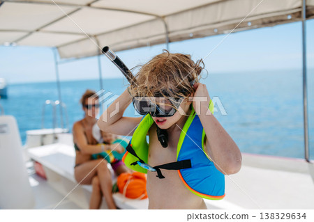 Kids snorkeling near boat during tropical family vacation. Kids snorkeling near boat during tropical family vacation. 138329634