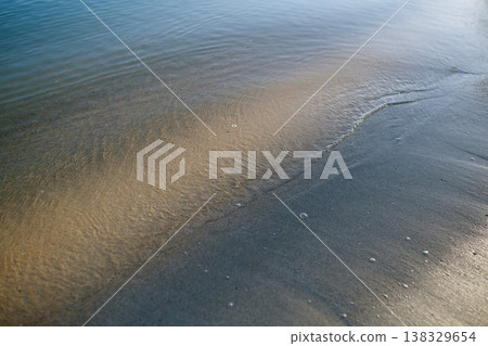 Gentle sea wave on sandy beach, calm tropical atmosphere. Gentle sea wave on sandy beach, calm tropical atmosphere. 138329654