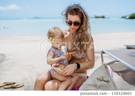 Mother with little toddler daughter on tropical beach vacation. Mother with little toddler daughter on tropical beach vacation. 138329665