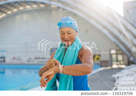 Senior woman getting ready for swim. Senior woman getting ready for swim. 138329706