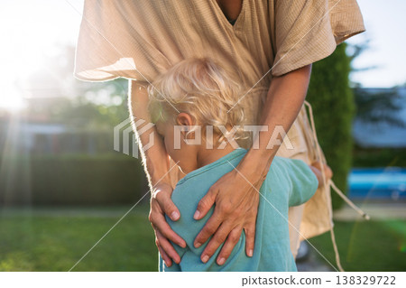 Candid shot of mom and little toddler son. Candid shot of mom and little toddler son. 138329722