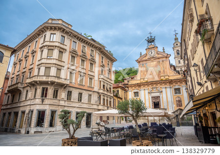 Mondovi (cuneo), italy, july 21,2024. Mondovi piazza maggiore capturing historic architecture, cobblestone square, and a cafe area under a cloudy sky Mondovi (cuneo), italy, july 21,2024. Mondovi piazza maggiore capturing historic architecture, cobblestone square, and a cafe area under a cloudy sky 138329779