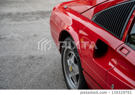 Mondovi (cuneo), italy, july 21, 2024. Ferrari rally. Red ferrari sports car body and wheel detail on asphalt. Emphasizing elegance, speed, and vintage automotive design 138329781