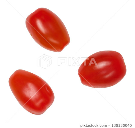 Three ripe red cherry tomatoes of elongated shape, isolated background Three ripe red cherry tomatoes of elongated shape, isolated background 138330040