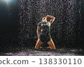 Contemporary woman dancer posing in rain water on black background. Female artist performer dancing with expression. Modern ballerina dancing in darkness. Passion dance in dark. Flexibility balance 138330110