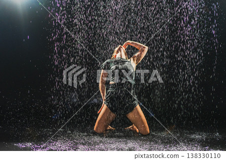 Contemporary woman dancer posing in rain water on black background. Female artist performer dancing with expression. Modern ballerina dancing in darkness. Passion dance in dark. Flexibility balance Contemporary woman dancer posing in rain water on black background. Female artist performer dancing with expression. Modern ballerina dancing in darkness. Passion dance in dark. Flexibility balance 138330110
