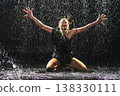 Contemporary woman dancer posing in rain water on black background. Female artist performer dancing with expression. Modern ballerina dancing in darkness. Passion dance in dark. Flexibility balance 138330111