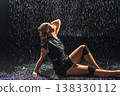 Contemporary woman dancer posing in rain water on black background. Female artist performer dancing with expression. Modern ballerina dancing in darkness. Passion dance in dark. Flexibility balance 138330112