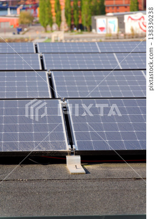 Solar panels on roof of apartment housing building with Gothenburg city center in background, Sweden, renewable green sustainable energy concept 138330238