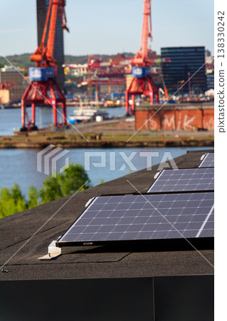 Solar panels on roof of apartment housing building with Gothenburg city center in background, Sweden, renewable green sustainable energy concept Solar panels on roof of apartment housing building with Gothenburg city center in background, Sweden, renewable green sustainable energy concept 138330242