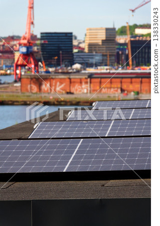 Solar panels on roof of apartment housing building with Gothenburg city center in background, Sweden, renewable green sustainable energy concept Solar panels on roof of apartment housing building with Gothenburg city center in background, Sweden, renewable green sustainable energy concept 138330243