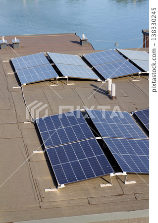 Solar panels on roof of apartment housing building with Gothenburg city center in background, Sweden, renewable green sustainable energy concept Solar panels on roof of apartment housing building with Gothenburg city center in background, Sweden, renewable green sustainable energy concept 138330245
