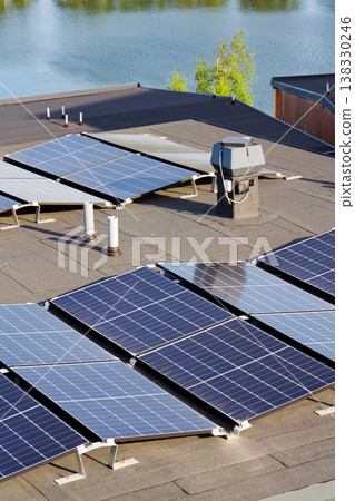 Solar panels on roof of apartment housing building with Gothenburg city center in background, Sweden, renewable green sustainable energy concept Solar panels on roof of apartment housing building with Gothenburg city center in background, Sweden, renewable green sustainable energy concept 138330246