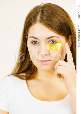 Woman with gold patches under eyes 138330270