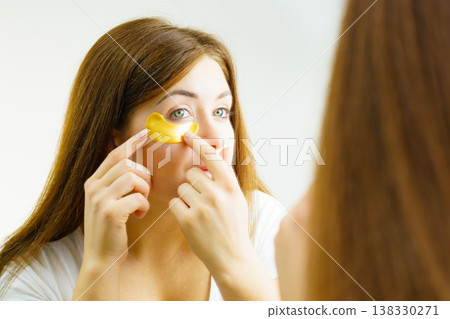 Woman with gold patches under eyes Woman with gold patches under eyes 138330271