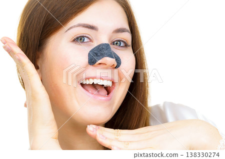 Woman applying pore strips on nose Woman applying pore strips on nose 138330274
