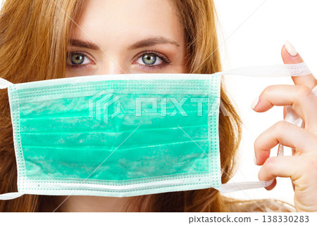 Female using protective face mask. Female using protective face mask. 138330283