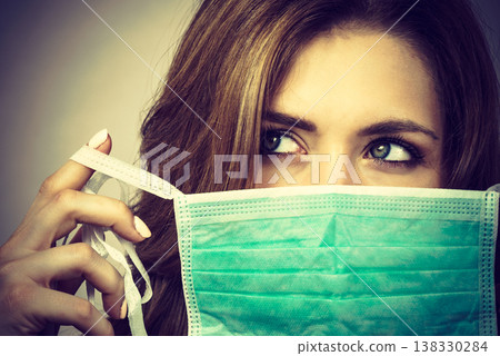 Female using protective face mask. Female using protective face mask. 138330284