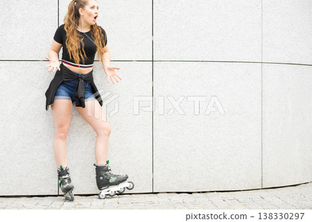 Young woman riding roller skates Young woman riding roller skates 138330297
