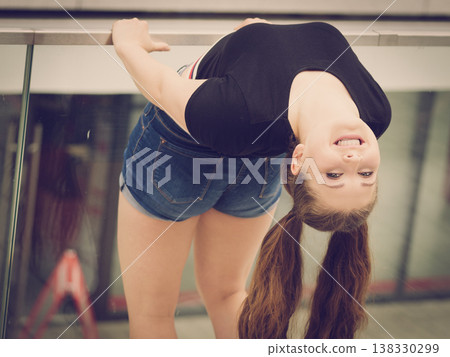 Funny woman flexing outdoor 138330299