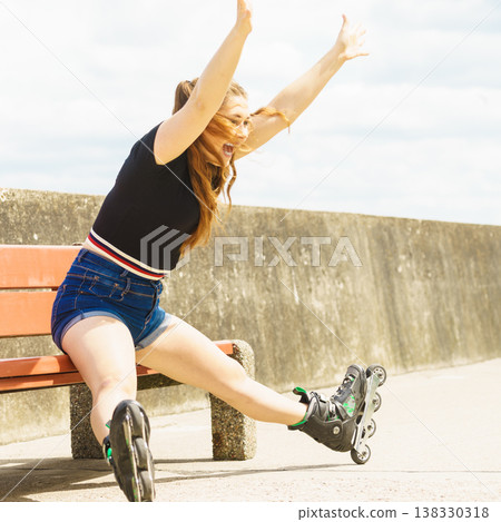Joyful girl wearing roller skates Joyful girl wearing roller skates 138330318