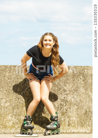 Fit girl with roller skates outdoor 138330319