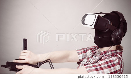 Gamer man wearing VR holding gun Gamer man wearing VR holding gun 138330415