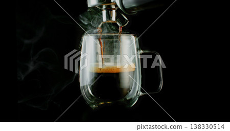 Fresh espresso pouring from coffee machine into glass cup with rich crema and rising steam. Warm cinematic scene capturing preparation of black coffee in cozy atmosphere. 138330514