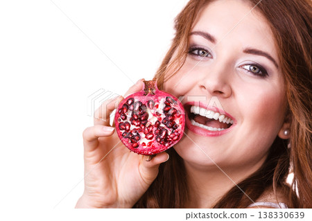 Cheerful woman holds pomegranate fruits, isolated Cheerful woman holds pomegranate fruits, isolated 138330639