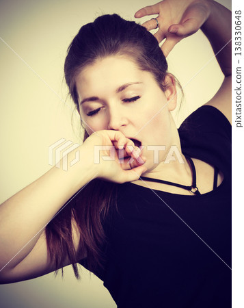 Young tired woman yawning Young tired woman yawning 138330648