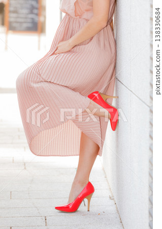 Woman in long dress and high heels on street Woman in long dress and high heels on street 138330684