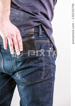 Closeup. Careless man taking wallet out on back pocket. Theft. 138330746